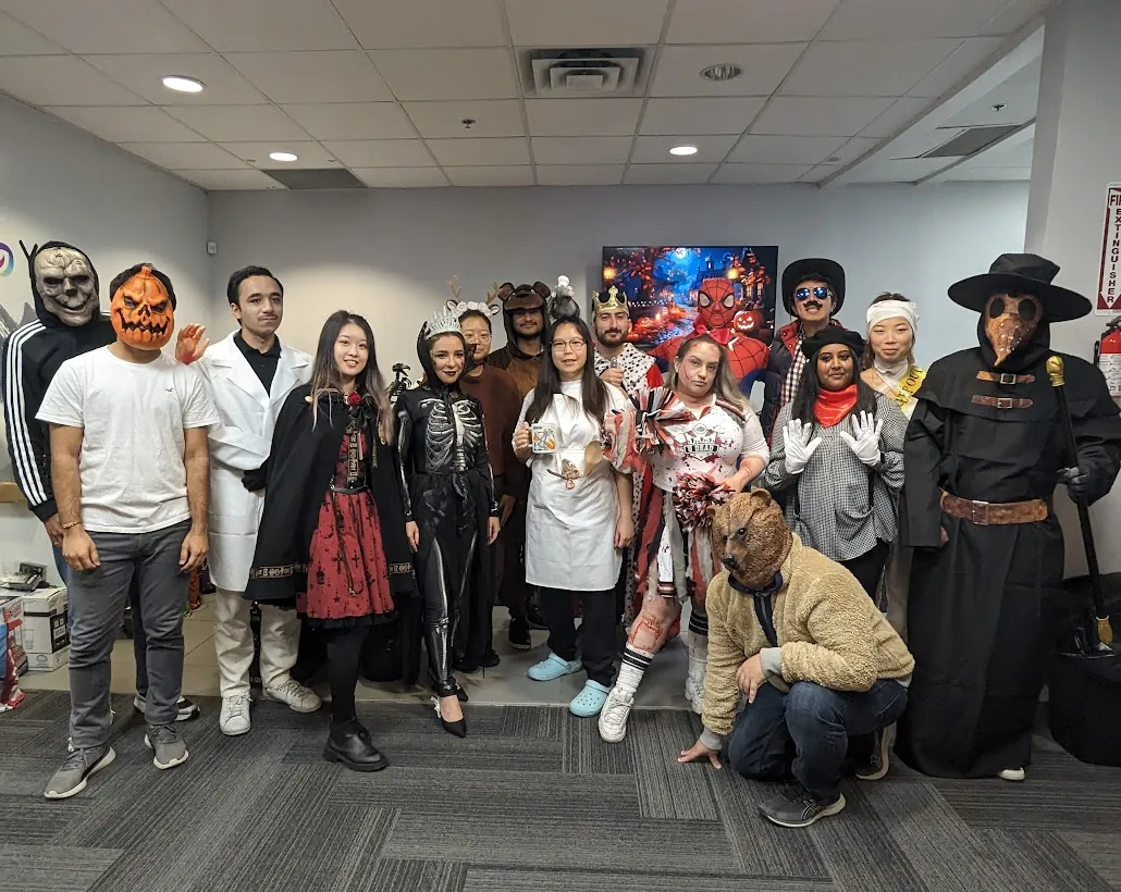 Vibrant Halloween costumes worn by a group of YuJa's team members.